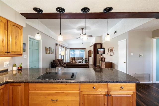 4401 Apollo Dr, Metairie, LA 70003 - kitchen featuring black electric cooktop, a ceiling fan, open floor plan, a textured ceiling, and brown cabinets