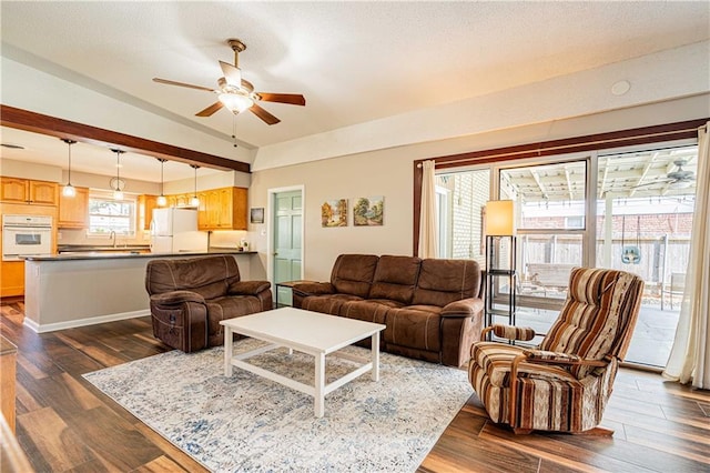 4401 Apollo Dr, Metairie, LA 70003 - living area featuring a ceiling fan, dark wood-type flooring, and baseboards