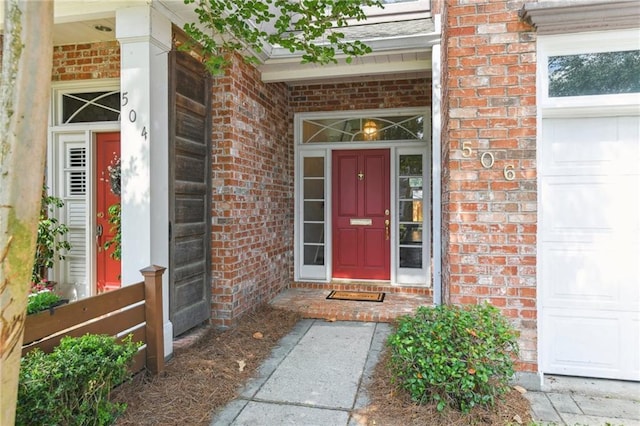 506 Papworth Ave, Metairie, LA 70005 - doorway to property featuring brick siding, a porch, and a garage