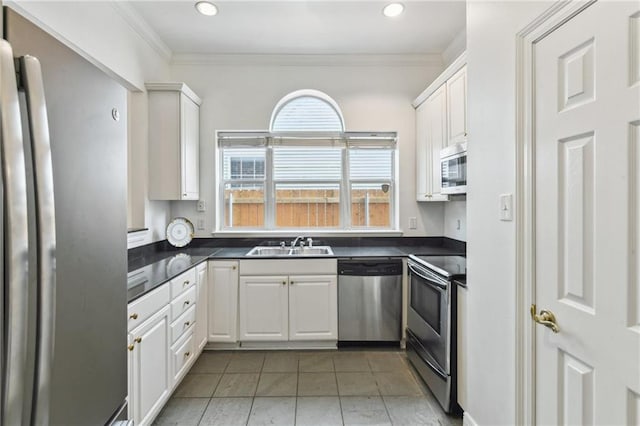 506 Papworth Ave, Metairie, LA 70005 - kitchen with appliances with stainless steel finishes, a sink, ornamental molding, dark countertops, and white cabinets
