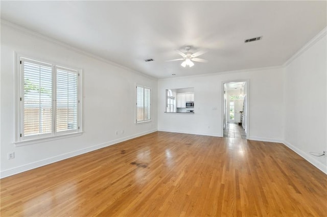 506 Papworth Ave, Metairie, LA 70005 - unfurnished living room featuring ornamental molding, ceiling fan, baseboards, and light wood-style floors