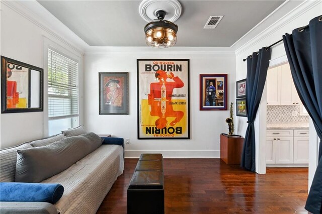 2728 Bienville St, New Orleans, LA 70119 - living area featuring dark wood finished floors, baseboards, and ornamental molding