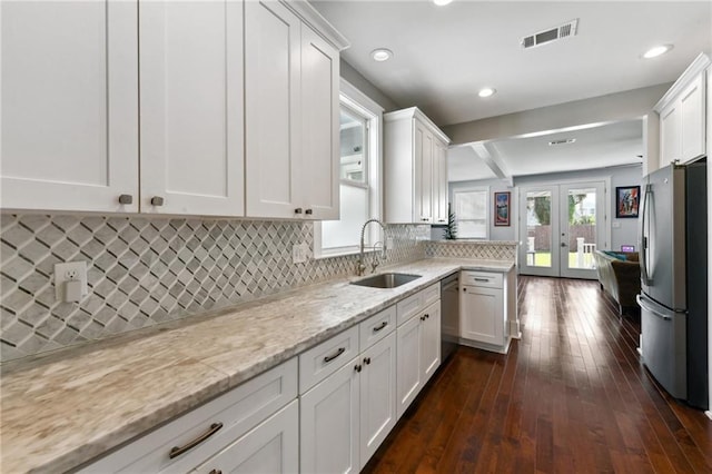 2728 Bienville St, New Orleans, LA 70119 - kitchen featuring stainless steel appliances, a sink, white cabinetry, french doors, and recessed lighting