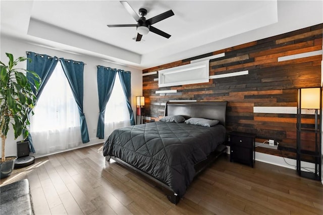 2728 Bienville St, New Orleans, LA 70119 - bedroom with wood walls, a raised ceiling, wood finished floors, and an accent wall