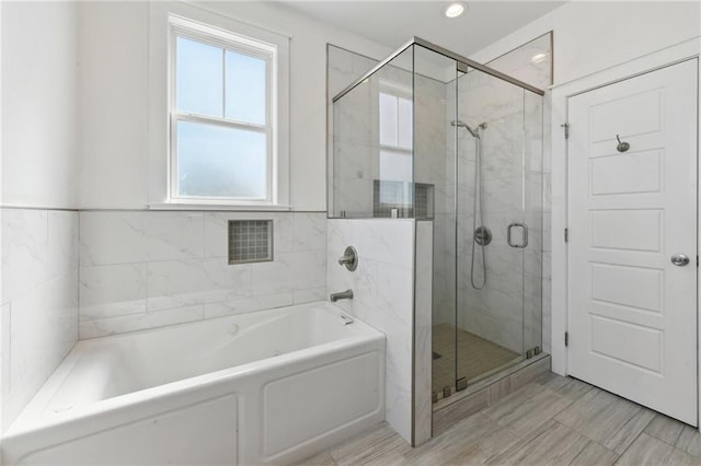 2728 Bienville St, New Orleans, LA 70119 - bathroom with a bath, a shower stall, and recessed lighting