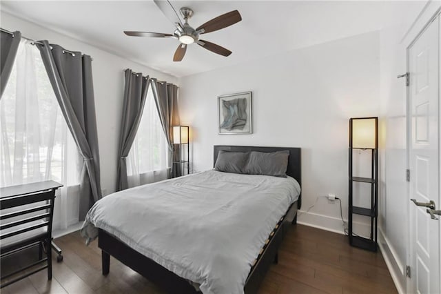 2728 Bienville St, New Orleans, LA 70119 - bedroom with multiple windows, baseboards, and dark wood-style floors