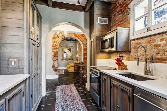 826 Bourbon St Unit B, New Orleans, LA 70116 - kitchen with stainless steel appliances, light countertops, and arched walkways