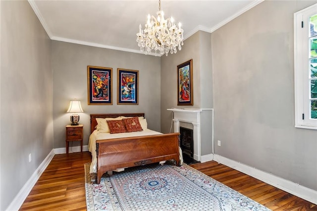 826 Bourbon St Unit B, New Orleans, LA 70116 - bedroom featuring wood finished floors, a chandelier, multiple windows, ornamental molding, and a fireplace with flush hearth