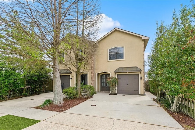 4444 Ligustrum St, Metairie, LA 70001 - view of front of house featuring stucco siding, driveway, and a garage