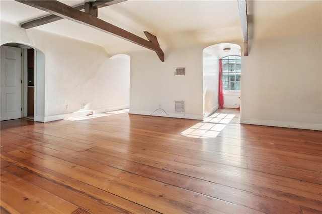519 Madison St Unit C, New Orleans, LA 70116 - unfurnished living room with arched walkways and hardwood / wood-style flooring