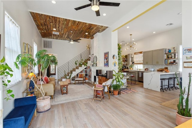 2712 Saint Thomas St, New Orleans, LA 70130 - living area featuring ceiling fan, light wood-style floors, stairway, a towering ceiling, and recessed lighting