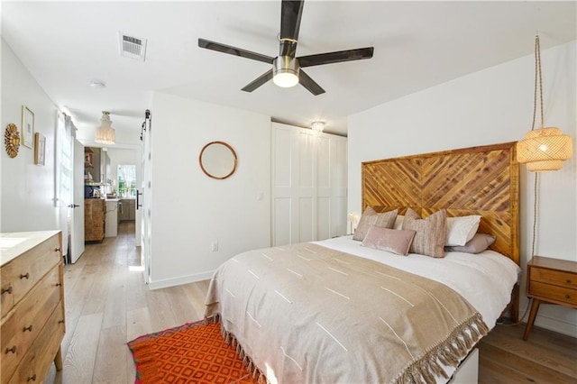 2712 Saint Thomas St, New Orleans, LA 70130 - bedroom featuring light wood-style flooring, a closet, and a ceiling fan