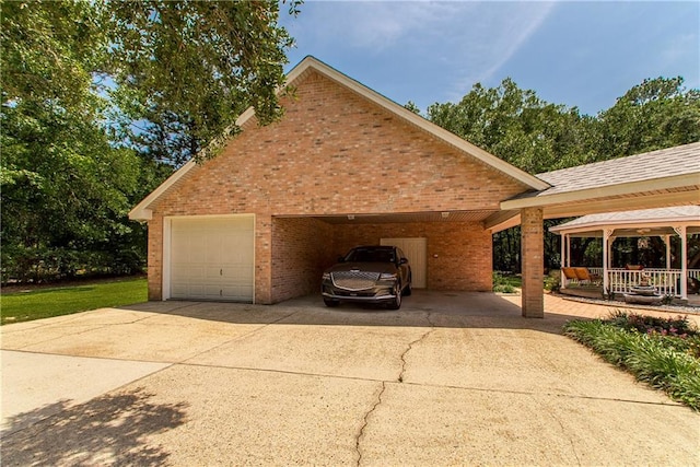view of home's exterior featuring brick siding, driveway, a garage, and a carport