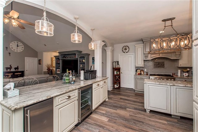kitchen with wine cooler, open floor plan, dark wood-style floors, a peninsula, and decorative backsplash