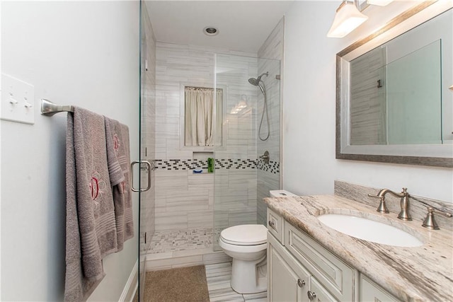 full bathroom with a stall shower, tile patterned floors, vanity, and toilet
