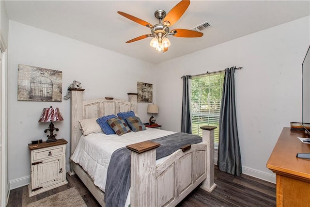 bedroom with dark wood-style floors, baseboards, and ceiling fan