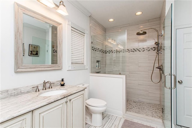 full bathroom with a stall shower, vanity, toilet, recessed lighting, and crown molding