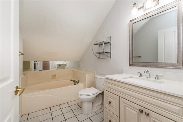 bathroom featuring vaulted ceiling, toilet, tile patterned floors, a garden tub, and vanity