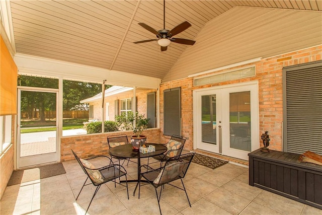 sunroom / solarium with french doors, vaulted ceiling, a ceiling fan, and outdoor dining space