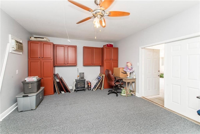 office featuring a wall mounted AC, light carpet, a ceiling fan, and baseboards
