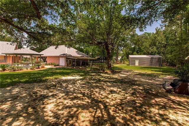 view of grassy yard with an outdoor structure and a shed