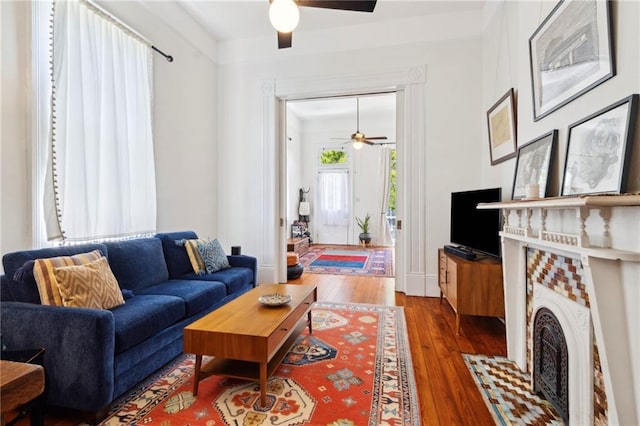 2329 Dauphine St, New Orleans, LA 70117 - living area featuring ceiling fan, hardwood / wood-style flooring, and a fireplace with flush hearth