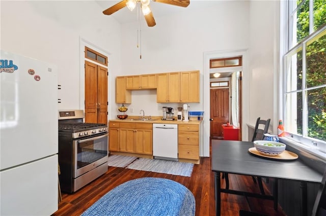 2329 Dauphine St, New Orleans, LA 70117 - kitchen with white appliances, a high ceiling, a sink, dark wood-style flooring, and a ceiling fan