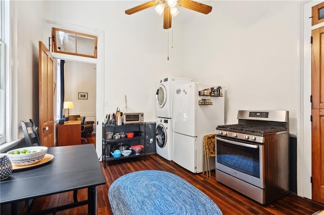 2329 Dauphine St, New Orleans, LA 70117 - kitchen with gas stove, stacked washing machine and dryer, freestanding refrigerator, ceiling fan, and dark wood-style floors