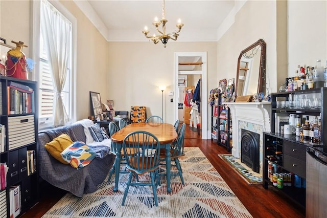 2329 Dauphine St, New Orleans, LA 70117 - dining space featuring a chandelier, wood finished floors, and a fireplace with flush hearth