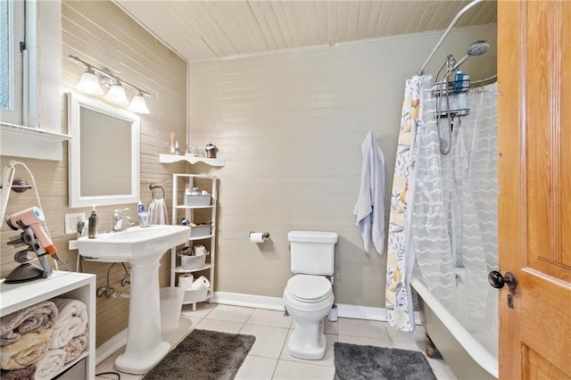 2329 Dauphine St, New Orleans, LA 70117 - full bath with tile patterned floors, toilet, wooden ceiling, baseboards, and shower / bath combo