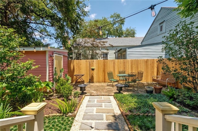 2329 Dauphine St, New Orleans, LA 70117 - fenced yard featuring a patio, an outdoor structure, and a storage unit