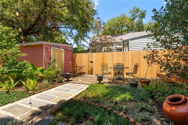2329 Dauphine St, New Orleans, LA 70117 - view of yard featuring a shed, an outdoor structure, fence, and a patio
