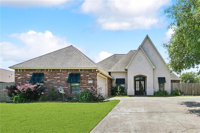 11446 Copperwood Dr, Denham Springs, LA 70726 - french country style house with french doors, an attached garage, driveway, roof with shingles, and brick siding