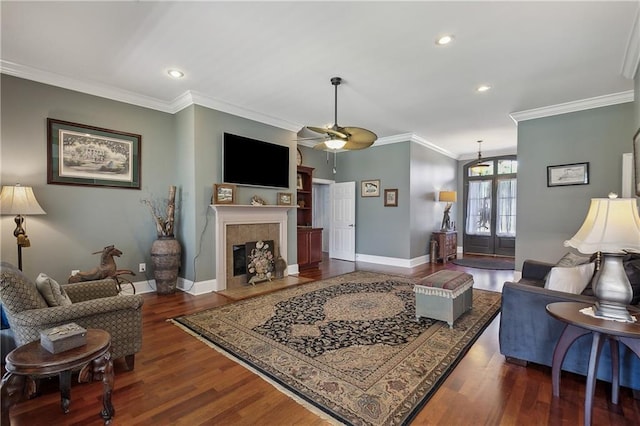 11446 Copperwood Dr, Denham Springs, LA 70726 - living room with wood finished floors, a ceiling fan, crown molding, a high end fireplace, and baseboards