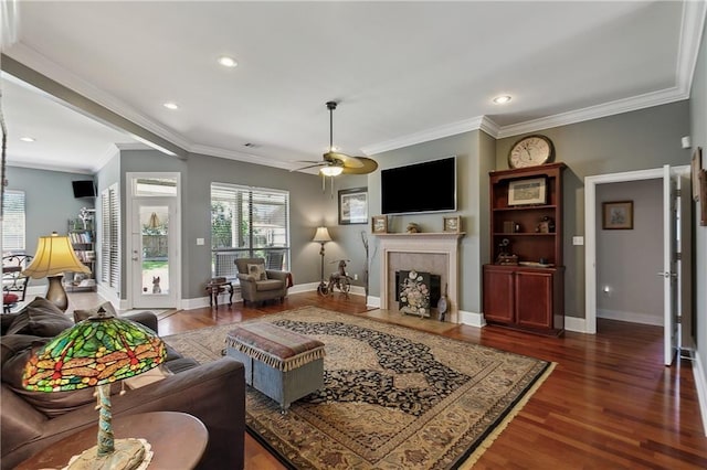 11446 Copperwood Dr, Denham Springs, LA 70726 - living room featuring plenty of natural light, a tiled fireplace, dark wood-style flooring, ornamental molding, and recessed lighting