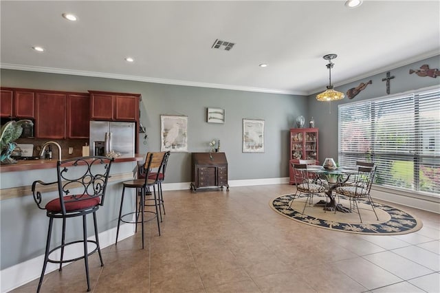 11446 Copperwood Dr, Denham Springs, LA 70726 - kitchen with stainless steel fridge with ice dispenser, recessed lighting, ornamental molding, a peninsula, and a breakfast bar area