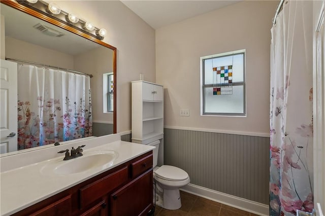 11446 Copperwood Dr, Denham Springs, LA 70726 - full bath with a wainscoted wall, vanity, toilet, tile patterned floors, and a shower with shower curtain