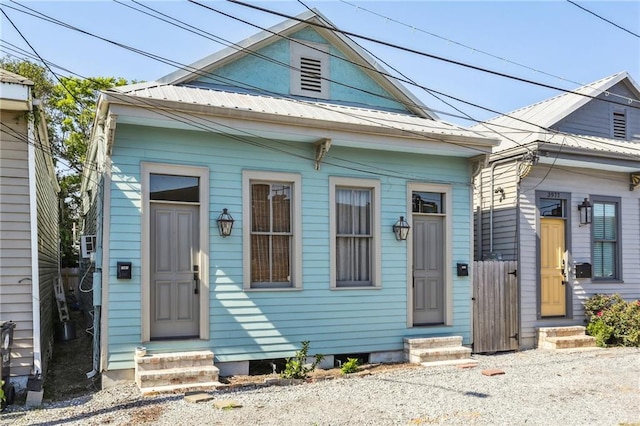 3979 S Front St, New Orleans, LA 70115 - shotgun-style home with entry steps and metal roof
