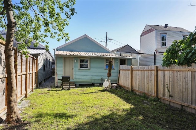 3979 S Front St, New Orleans, LA 70115 - rear view of house with metal roof and entry steps
