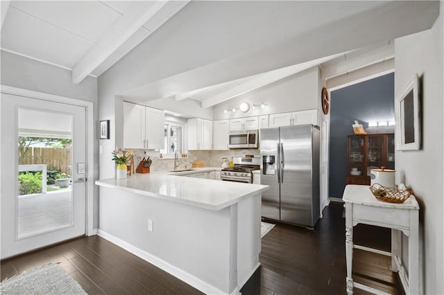 33 Caribou Ct, Metairie, LA 70003 - kitchen featuring stainless steel appliances, a sink, a peninsula, white cabinets, and light countertops