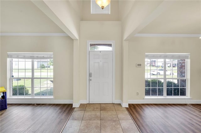 682 Amy Ct, Covington, LA 70433 - foyer entrance featuring crown molding, wood finished floors, plenty of natural light, baseboards, and a high ceiling