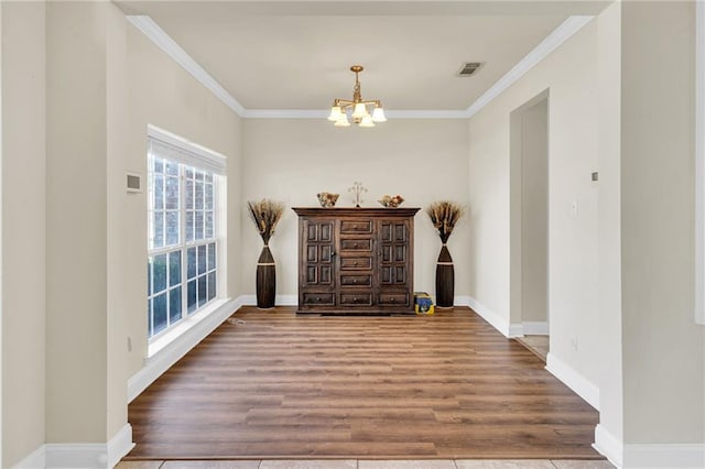 682 Amy Ct, Covington, LA 70433 - entryway with a chandelier, wood finished floors, crown molding, and baseboards