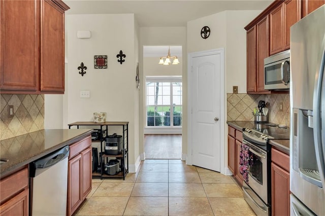 682 Amy Ct, Covington, LA 70433 - kitchen with stainless steel appliances, a chandelier, backsplash, and light tile patterned floors