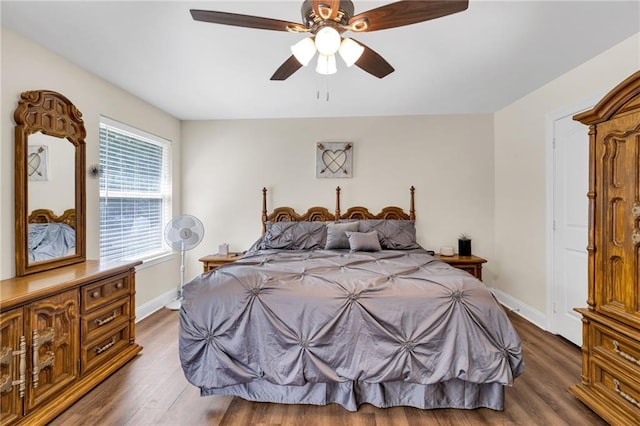 682 Amy Ct, Covington, LA 70433 - bedroom with dark wood-style flooring, baseboards, and a ceiling fan