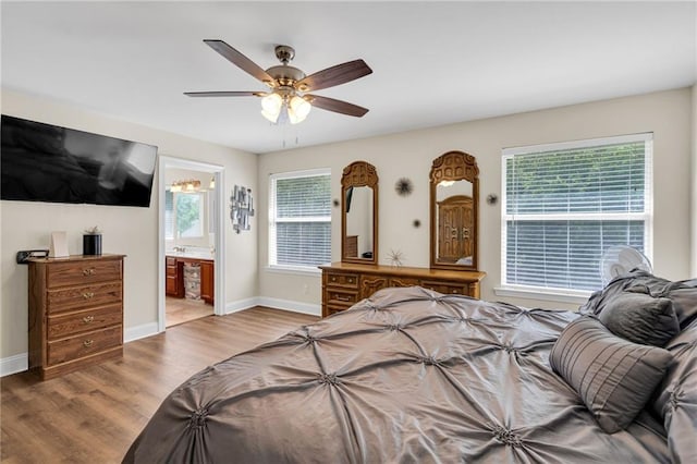 682 Amy Ct, Covington, LA 70433 - bedroom with wood finished floors, baseboards, a ceiling fan, and ensuite bathroom