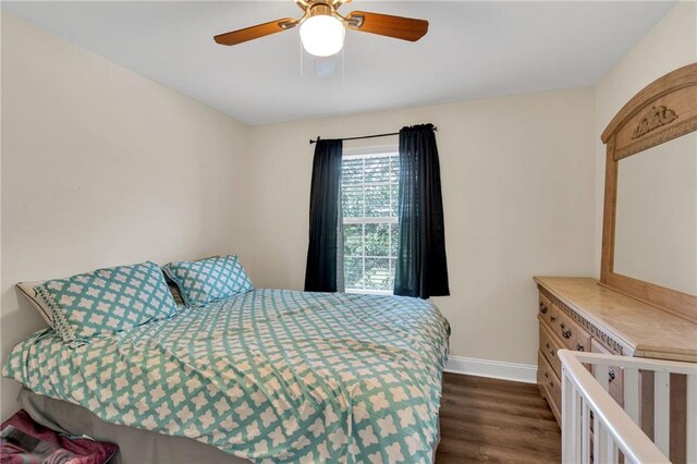 682 Amy Ct, Covington, LA 70433 - bedroom featuring baseboards, dark wood-type flooring, and ceiling fan