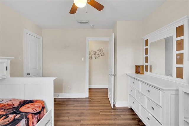 682 Amy Ct, Covington, LA 70433 - bedroom with dark wood-style flooring, baseboards, and ceiling fan