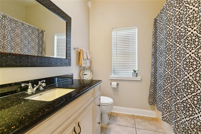 1681 Vela Cv, Slidell, LA 70458 - bathroom featuring vanity, toilet, tile patterned flooring, baseboards, and curtained shower