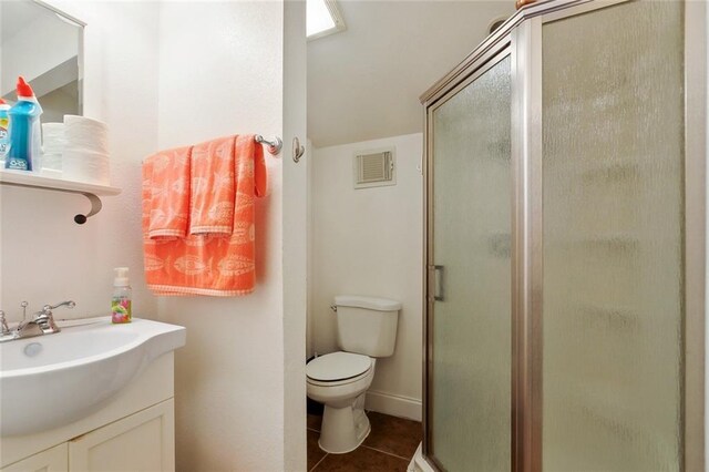 1681 Vela Cv, Slidell, LA 70458 - full bath with a shower stall, vanity, tile patterned floors, and toilet