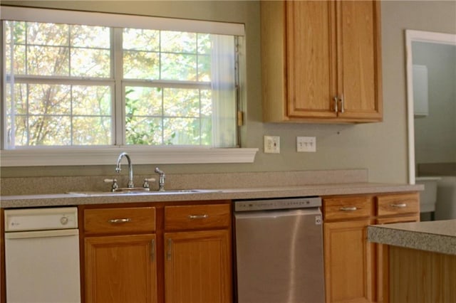 66165 Hickory Dr, Pearl River, LA 70452 - kitchen with stainless steel dishwasher, plenty of natural light, light countertops, and a sink